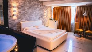 a bedroom with a large bed and a bathroom at Altana Motel in Brasília