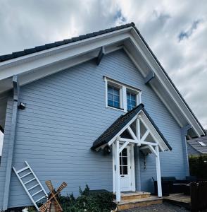 a blue house with a white door at Ferienwohnung“puutalossa“ in Sehlen