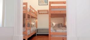 two bunk beds in a room with a staircase at ten2twelve in Espinho