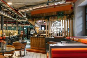 a restaurant with tables and chairs and a sign that reads the good place at The Social Hub Madrid 4 star in Madrid +39 photos