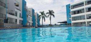 a swimming pool in front of some buildings at Paraíso del sol in San Jerónimo +10 photos