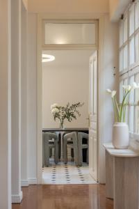 a dining room with a table with a vase of flowers at Once&Forever Estate in Athens +115 photos