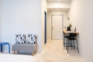 a bedroom with a desk and a chair and a table at Blue Studio in Xanthi
