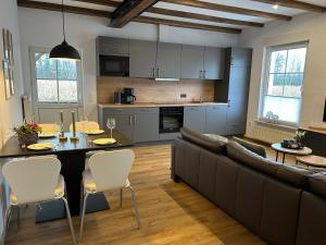 a kitchen and living room with a couch and a table at Landidyll Georg in Ostbevern