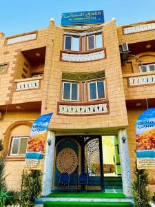 a building with a sign on the front of it at Al-BARNY HOTEL in Siwa