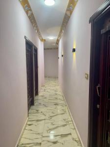 an empty hallway with a tile floor and a door at Al-BARNY HOTEL in Siwa +1 photo