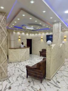 a man standing at a counter in a lobby at Al-BARNY HOTEL in Siwa