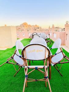 a group of chairs sitting on the grass at Al-BARNY HOTEL in Siwa