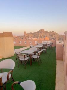 a row of tables and chairs on a roof at Al-BARNY HOTEL in Siwa