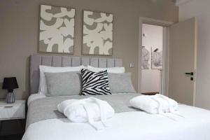 a bedroom with a white bed with two towels on it at Theasis apt in Neméa