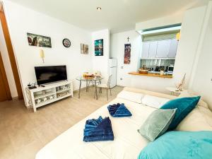 a living room with a couch and a television at Adeje Paradise dreams in Playa Paraiso