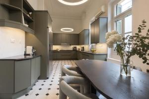 a kitchen with a wooden table and chairs at Once&Forever Estate in Athens