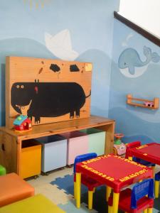 a room with a toy cow on the wall at Pousada Terra Nostra in Prado