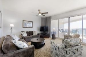 a living room with a couch and chairs and a ceiling fan at TOPS'L Tides II in Destin
