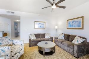a living room with two couches and a table at TOPS'L Tides II in Destin