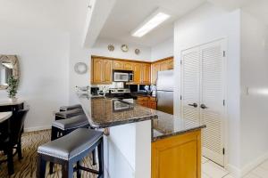 a kitchen with wooden cabinets and a counter top at TOPS'L Tides II in Destin