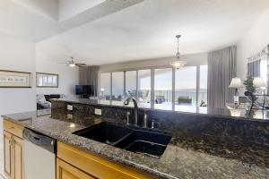 a kitchen with a sink and a view of the ocean at TOPS'L Tides II in Destin +28 photos