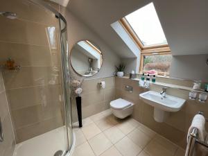 a bathroom with a shower and a toilet and a sink at Copper Beeches in Elgin