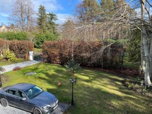 a car parked in the driveway of a yard at Copper Beeches in Elgin