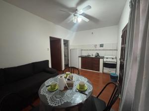 ein Wohnzimmer mit einem Tisch und einem Sofa in der Unterkunft Descanso Perfecto Ruta 34, Wifi, Cochera e Ideal para Viajeros, 3 personas in Fernández
