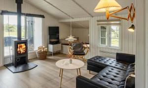 a living room with a couch and a fireplace at VE134-Vejers-Strand-Jafdalvej-89 in Vejers Strand