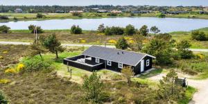 an aerial view of a house with a lake at VE134-Vejers-Strand-Jafdalvej-89 in Vejers Strand