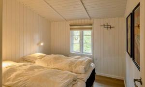 a bed in a room with a window at VE134-Vejers-Strand-Jafdalvej-89 in Vejers Strand