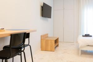 a room with a desk and a chair and a bed at Blue Studio in Xanthi +17 photos