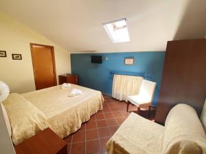a hotel room with two beds and a chair at Caterina House in San Lucido