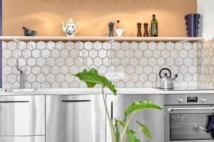 a kitchen with white tiles on the wall at O'Hara in Horní Blatná