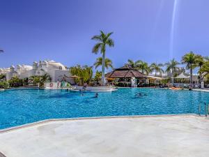 a pool at a resort with people in the water at Adeje Paradise dreams in Playa Paraiso