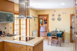 a kitchen with a table and a dining room at Villa dos Teixos in Cascais