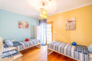 a bedroom with two beds and a window at Villa dos Teixos in Cascais +75 photos