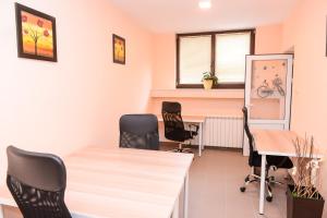 an office with chairs and a desk and a window at Балкан вили in Ribarica +25 photos