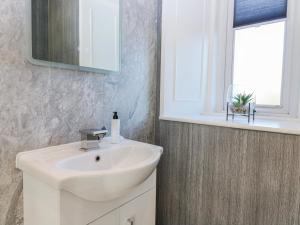 a bathroom with a sink and a mirror and a window at Little Norwood in Perth +17 photos