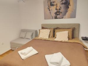 a bedroom with a bed and a couch at Kael apartment-near Airport in Skopje