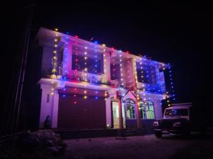 a house with christmas lights on it at night at Hotel Silver Cloud in Pelling