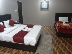 a bedroom with a large bed with towels on it at Hotel Silver Cloud in Pelling