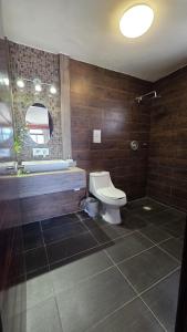 a bathroom with a toilet and a tub and a sink at Casita Maya Bacalar in Bacalar +87 photos