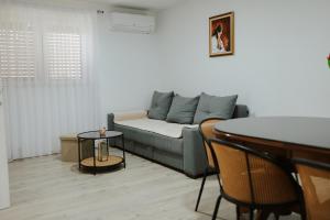 a living room with a couch and a table at Guest house Ivan in Međugorje