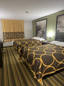 a hotel room with two large beds in it at Super 8 by Wyndham Chanute in Chanute