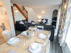 a living room with a table and a couch at Cha Cha's Cottage in Whitby