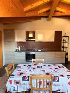 a kitchen with a table with a tablecloth on it at Mansarda Il Castello in Ossana +15 photos