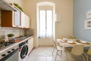 a kitchen with a table and a sink and a dishwasher at Vestamonti Apartment in La Spezia