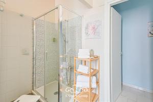a shower in a bathroom with a glass shower stall at Vestamonti Apartment in La Spezia