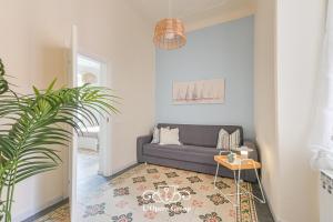 a living room with a couch and a plant at Vestamonti Apartment in La Spezia +20 photos
