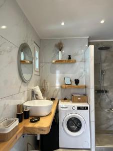 a bathroom with a sink and a washing machine at Samos Blue Haven in Samos