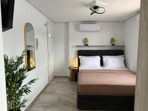 a bedroom with a bed and a ceiling fan at Samos Blue Haven in Samos