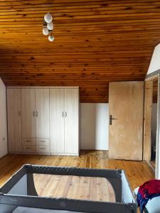 an empty room with a wooden ceiling and a tub at Panorama Residence Ivan in Pljevlja