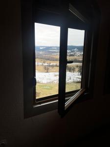 a window in a room with a view of a field at Panorama Residence Ivan in Pljevlja +19 photos